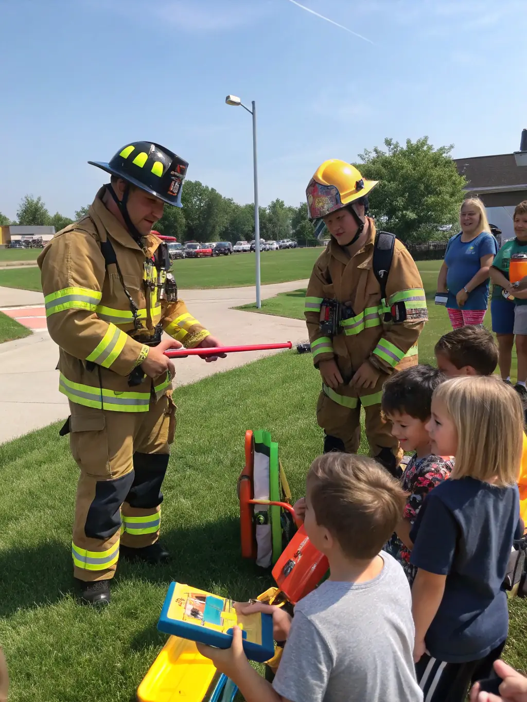 A photo of sapeurs-pompiers visiting a local school to educate children about fire safety, demonstrating their commitment to prevention and community education.